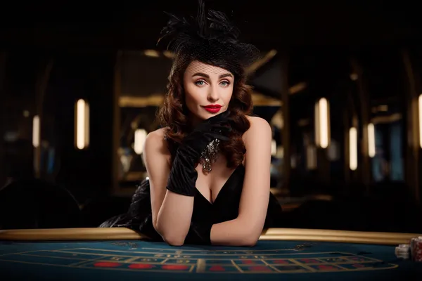 A glamorous woman holding casino chips in a neon-lit environment, representing the premium online casino atmosphere of SPINARA.